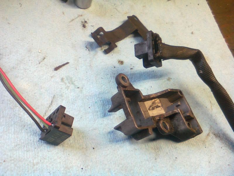Old crank sensor disassembled, new one ready to swap in